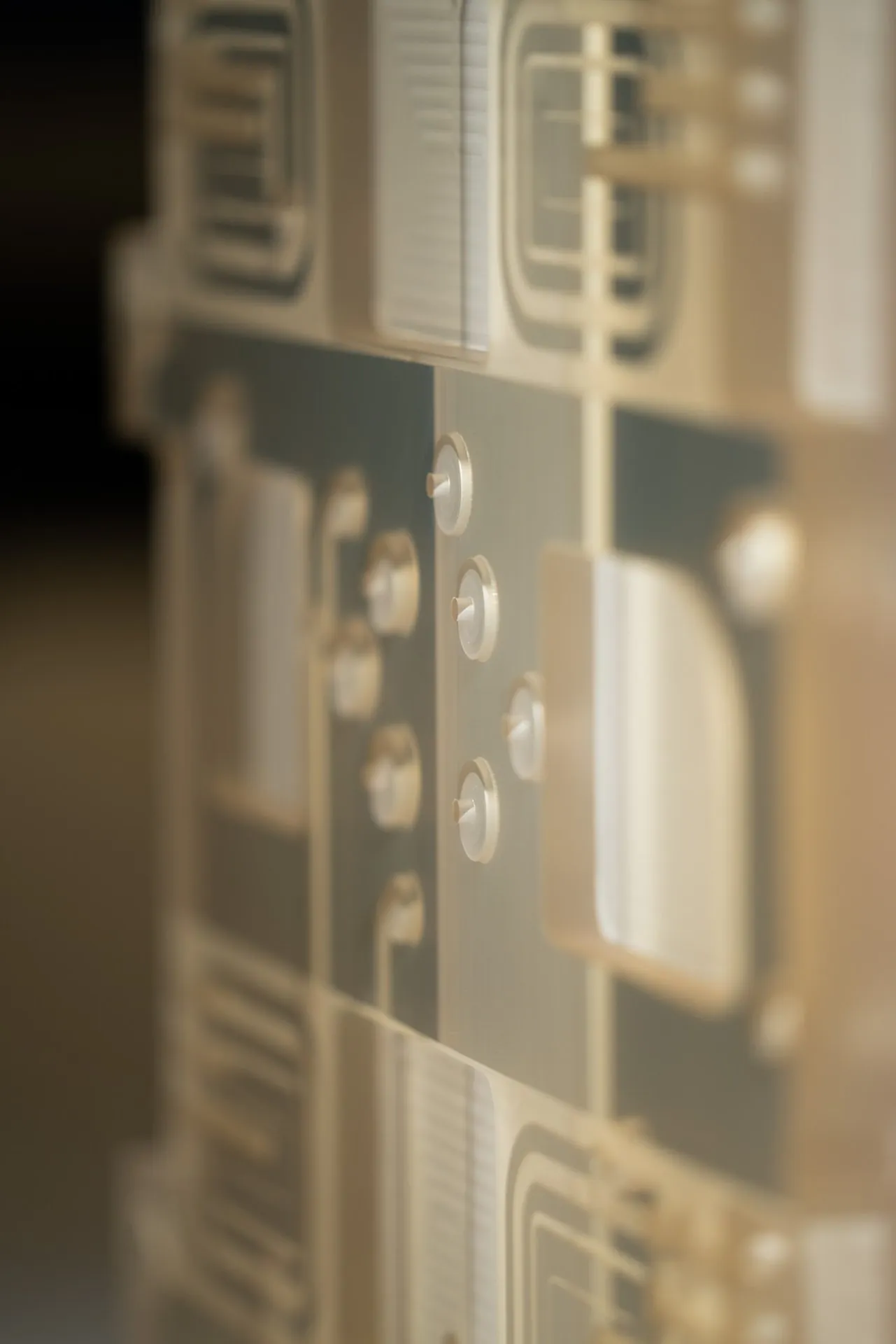 Close-up of a glass-ceramic part with milled pockets and small pins